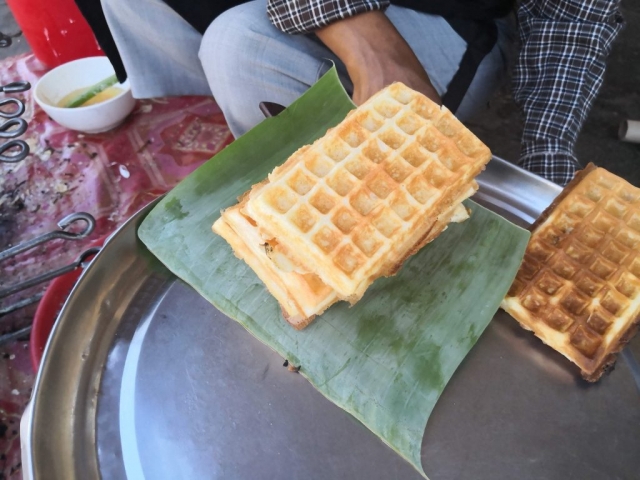 Ms Laum makes Num Poum (Khmer waffles) in Siem Reap